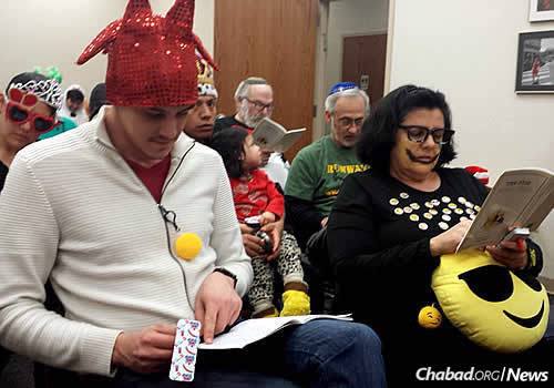 John Doherty, second row, an active community member who has called Indiana home for 15 years, hears the Megillah read on Purim. In front are Elyahu and Leah Herszberg.