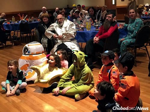 Elizabeth Graves, far left, and other children at this year’s “Purim in Outer Space” event.