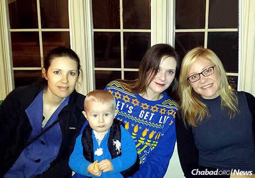 Sisters Shoshannah Aumock, Leah Kovtonenko (with her son, Niko) and Alisa Shortell at the annual menorah-lighting and Chanukah party.