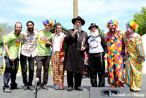 Rabbi David Cohen, center, has organized the Montreal parade for nearly 20 years. He’s shown here at last year’s event with some of the entertainers.