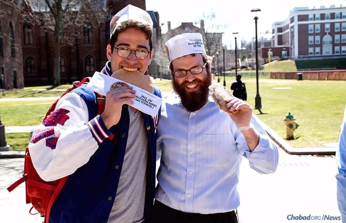 Chabad at Wesleyan University in Middletown, Conn., co-directed by Rabbi Levi and Chani Schectman, has purchased a building to offer more space for services, Shabbat dinners, classes, student programs and Jewish holiday events. Here, the rabbi and Sam Wachsberger display homemade shmurah matzah made at a “Model Matzah Bakery” workshop.