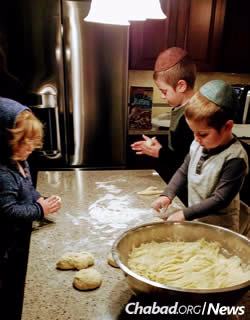The Telsner children help prepare challah.