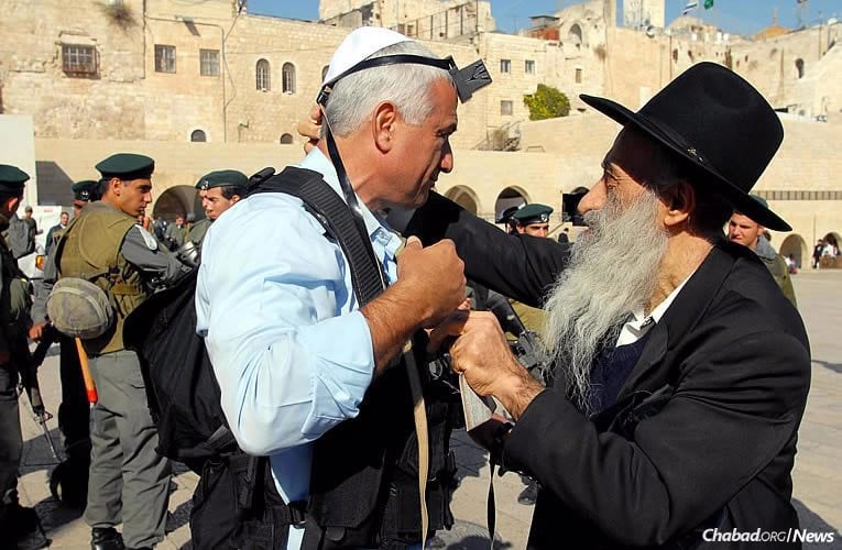 The Chabad-Lubavitch tefillin stand at the Western Wall in Jerusalem opened on June 15, 1967. Millions of Jews have since put on tefillin there, transforming emotions felt at one of Judaism’s holiest sites into action. (Photo: Mark Neyman/Israel Government Press Office)