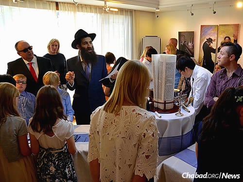 The rabbi talked about tallit, tefillin and Torah to guests. (Maitri Shah Photography)