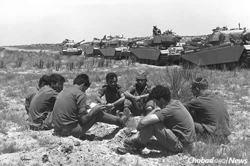 For weeks before the war, Israel slowly mobilized its reserves, with husbands, fathers and sons leaving their lives and reporting to active duty. While Israel attempted to negotiate a diplomatic solution to the crisis, they waited. Here, a tank unit awaits orders on the southern front. (Photo: Moshe Milner/Israel Government Press Office)