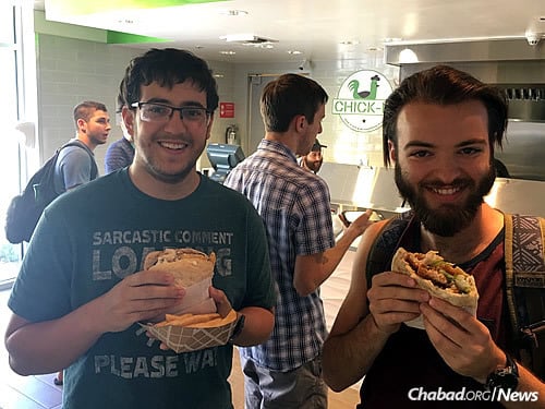 Eliyahu Gibly, left, and Hal Danesh take a break to enjoy a typical Israeli-style lunch.