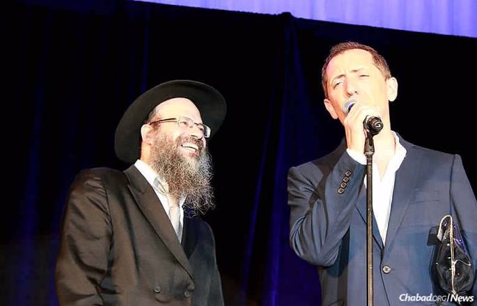 At a show in Montreal this month, comedian Gad Elmaleh recalled his days at Camp Tzivot Hashem in his native Morocco, where he developed a warm relationshp with Rabbi Leibel Raskin, and where his early humor became apparent. Here, Elmaleh shares a moment with the rabbi's son, Rabb Mendel Raskin, who co-directs Beth Chabad CSL, where the pro bono performance was held.