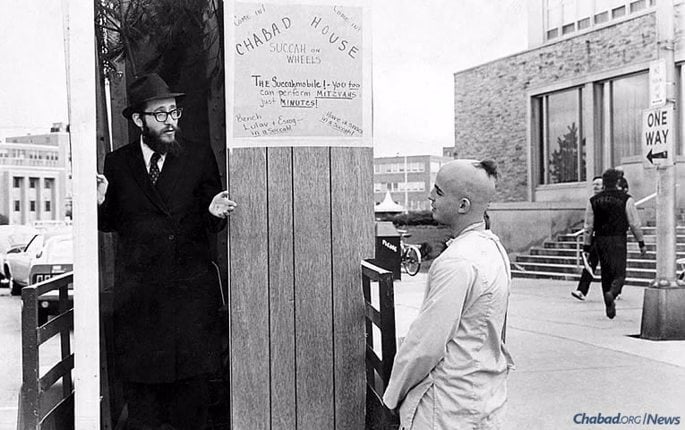 Rabbi Nosson Gurary, Chabad emissary in Buffalo, N.Y., speaks with a Jewish student on campus at SUNY Buffalo in the early 1970s. (Photo: Kehot Publication Society)