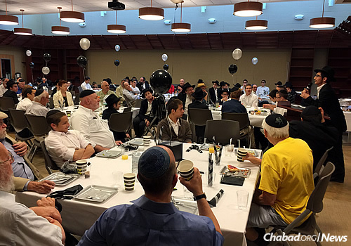 The room full of boys and guests. The goal was to honor the 50th year since the launch of the Tefillin Campaign by the Lubavitcher Rebbe, Rabbi Menachem M. Schneerson.