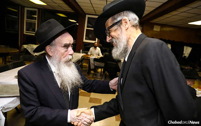 Rabbi Abraham Shemtov, left, chairman of Agudas Chasidei Chabad and director of Camp Gan Israel, greets Rabbi Leibel Shuchat, dean of Yeshiva Guedola de Venezuela rabbinical seminary in Caracas, to the Yarchei Kallah summit in Parkesville, N.Y. (Photo: Shimi Kutner)