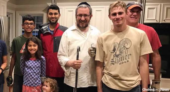 As soon as Rabbi Yossi Zaklikofsky, center, of Bellaire, Texas, put out the word that his home had flooded, friends and strangers arrived to help.
