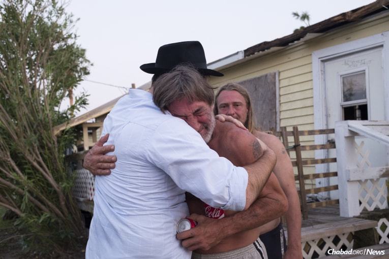 Chabad-Lubavitch Rabbi Naftoli Schmukler, left, of Corpus Christi, Texas, embraces and comforts Ed Flower, a local homeowner, who together with his brother, barely survived the hurricane in Port Aransas, Texas, on Thursday, Aug. 31, 2017. (Photo: Ver&#243;nica G. C&#225;rdenas/Chabad.org)