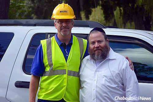 Rabbi Berl Goldman, co-director of Chabad Lubavitch Student Center in Gainesville, Fla., with a local emergency-services worker.