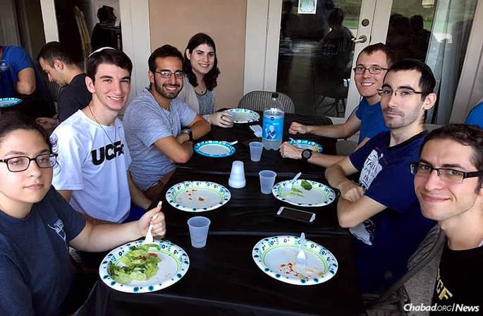 Many students sheltered and fed by Chabad on Campus centers in Florida during Hurricane Irma are out in communities helping others. During the storm, Jesse Slomowitz, bottom right, stayed at Chabad at the University of Central Florida in Oviedo, just outside of Orlando, and ate meals there afterwards with others.