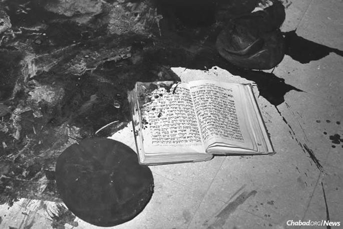 The attack, which prompted an outcry by Israel at the United Nations, shocked the young country and the world. This image of a blood-stained prayerbook on a blood-soaked floor symbolized the horror of the attack. (Photo: Moshe Pridan/Israel Government Press Office)