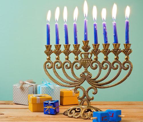 A Chanukah menorah on the eighth night, lit with candles.