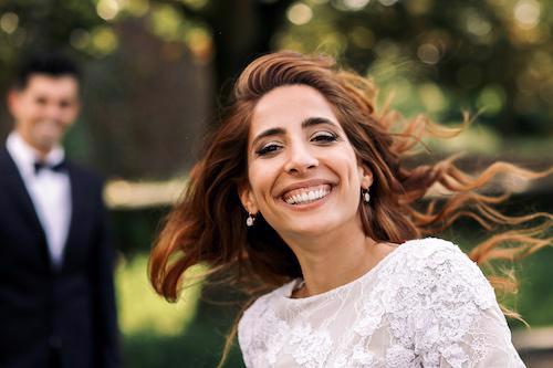 A Jewish bride smiles with delight.
