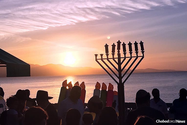 Chabad of Jamaica brought out local residents and tourists to a celebration that featured the kindling of an 8-foot-tall bamboo menorah.