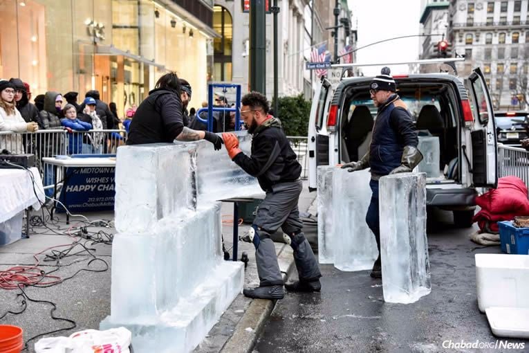 Assembling the Chanukah ice menorah sponsored by Chabad Lubavitch of Midtown Manhattan.