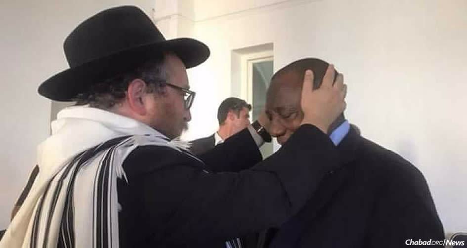 President Cyril Ramaphosa of South Africa receives a blessing from Rabbi Asher Deren, chairman of the Rabbinical Association of the Western Cape.