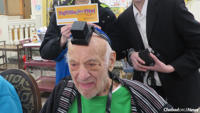 In Brooklyn, students helped a 105-year-old man put on tefillin.