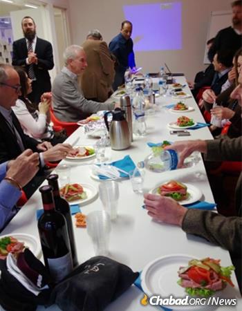 Rabbi Benyamin Wolff hosts a lunch for business leaders, complete with tefillin-wrapping.