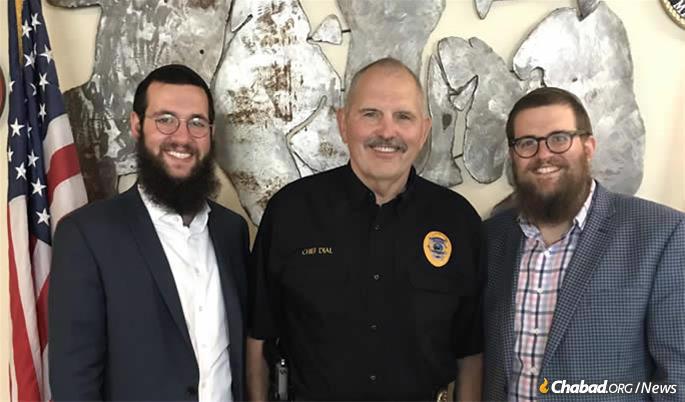 Wolf, left, with Whitefish police chief Bill Dial and Rabbi Chaim Bruk