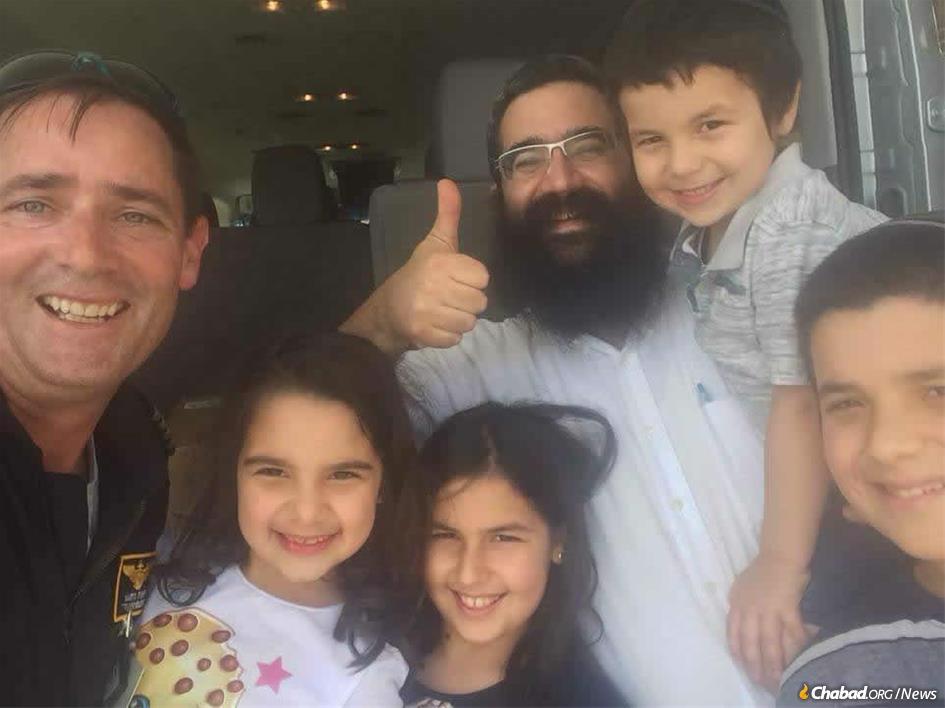 Rabbi Moshe Lieblich and children with the helicopter pilot who delivered much-needed supplies to Wilmington, N.C., just before Yom Kippur.