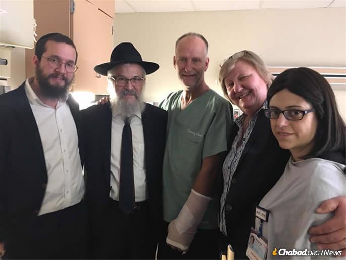 From left: Rabbi Henoch Rosenfeld, Rabbi Yisroel Rosenfeld, Officer Dan Mead, Diane Mead (Dan&#39;s sister) and Dr. Mylynda B Massart