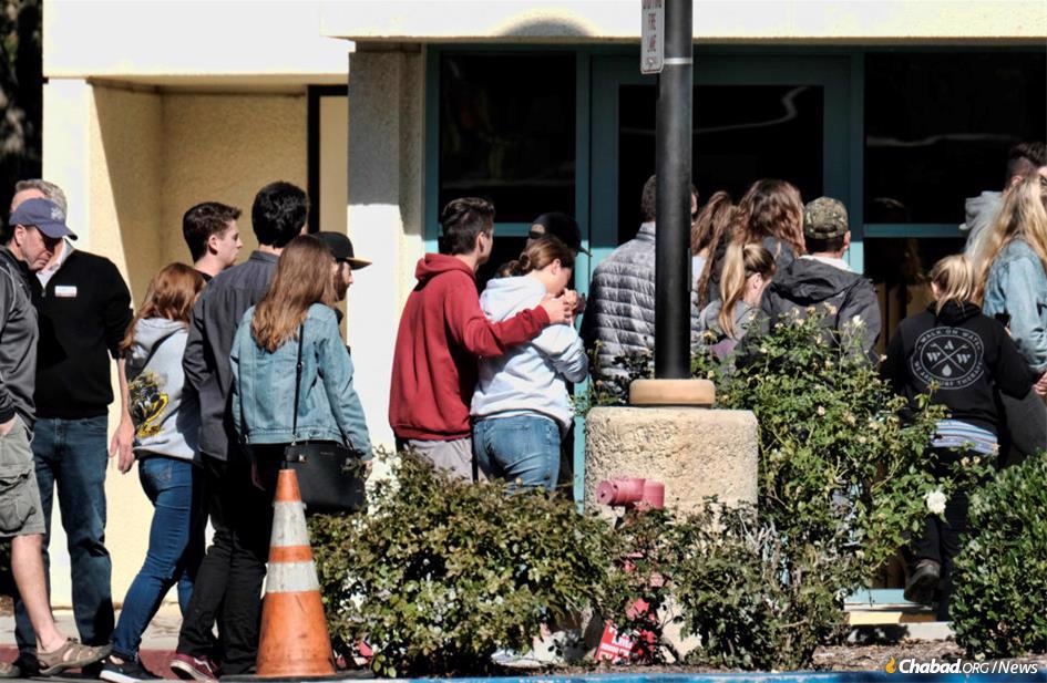 Families gather at the Thousand Oaks Teen Center to await news of their loved ones. (Photo: NPR)