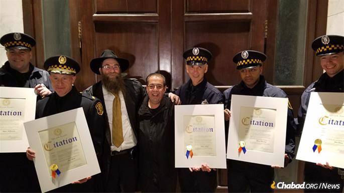 Rabbi Aaron Konikov, director of Chabad of Roslyn, with the officers.