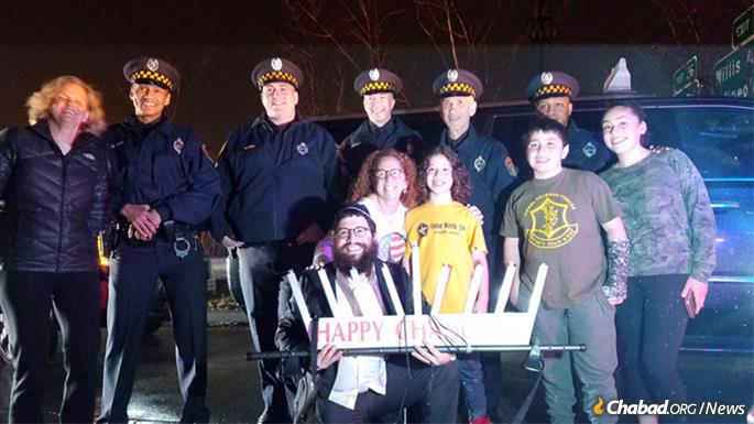 Neighborhood residents mingled with local officials and law-enforcement authorities, who also attended the lighting.
