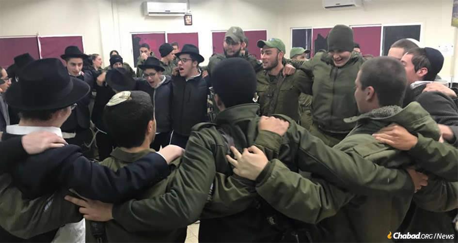 Yeshivah students from Safed dance with IDF troops in Metulla prior to an operation in which the troops destroyed a 40-meter-long-tunnel built by the Iranian-backed terror group Hezbollah. The tunnel started in the Lebanese town of Kfarkela and snaked its way into Metulla, an Israeli town of 1,000 surrounded on three sides by Lebanon.