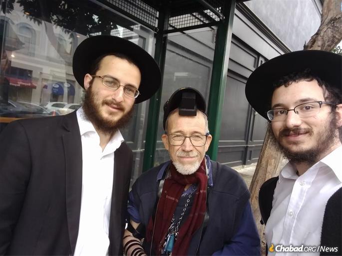 The rabbinical students helped this man put on tefillin for the first time.