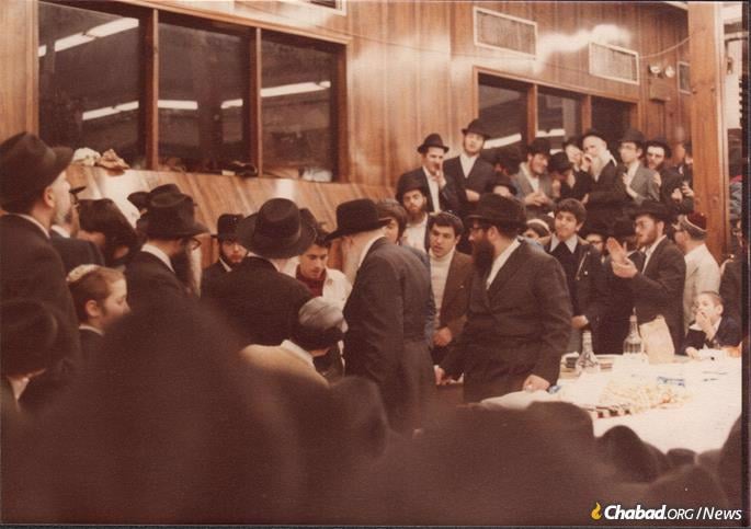 The Rebbe made a point to engage and encourage the Iranian children. For example, on Purim of 1979, the Rebbe had the Persian children seated together in a place of prominence and requested that they sing a Jewish song familiar to them. Seen here is a group of Iranian boys passing the Rebbe for Kos Shel Bracha. (Photo: Courtesy NCFJE)