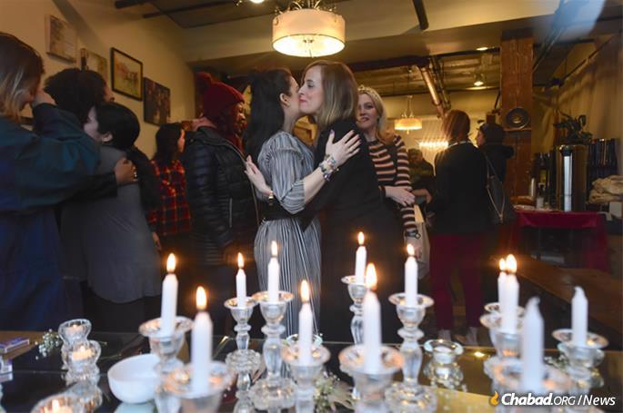 Women greet each other after candle-lighting before the onset of Shabbat. (Photo: Todd Maisel)