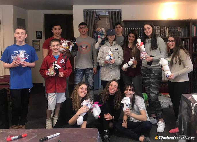 Students at a CTeen event at Chabad of Orange County display Purim packages they made for children in a local orphanage.