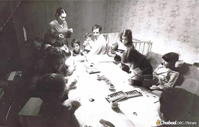 Young Dani Ash (seated at the head of the table) at a quasi-legal Jewish activity for children in Leningrad (now St. Petersburg).