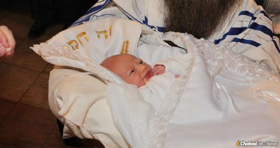 Menachem Mendel Morosov, pictured at his bris milah ceremony in Ulyanovsk, Russia, is among thousands of boys from around the world named after the Lubavitcher Rebbe. Publishers of a new book hope to chronicle every boy named after the Rebbe since his passing almost 25 years ago.