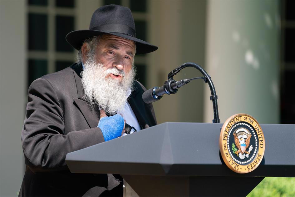 Rabbi Yisroel Goldstein speaking on the White House lawn days after he lost his finger in an act of terror in his Chabad center (Official White House Photo by Tia Dufour).