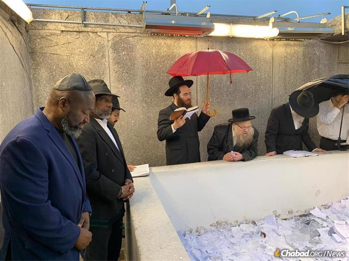 Matthew Charles at the resting place of the Rebbe, Rabbi Menachem M. Schneerson, of righteous memory, with Clive Williams.
