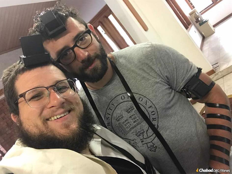 Zachary Bucheister, right, describes what it’s like to be part of Ghana’s tight-knit but chronically transient Jewish community, anchored by Rabbi Noach Majesky.