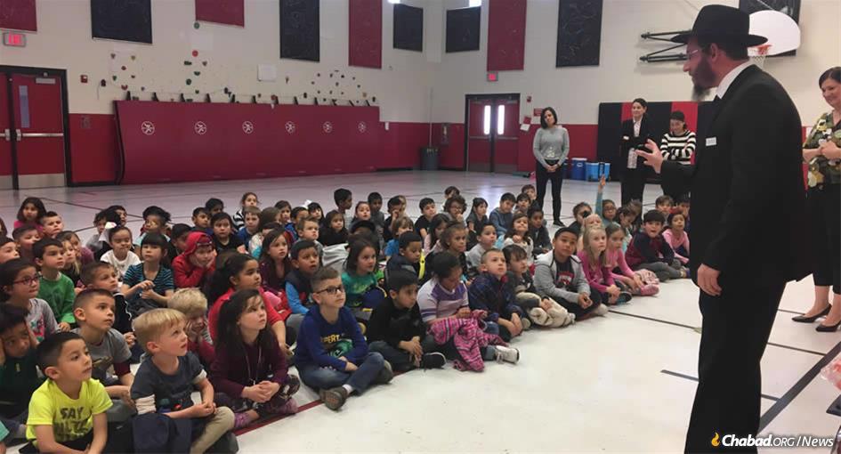 Rabbi Levi Greenberg talks to El Paso public-school children about the importance of giving charity and doing acts of kindness.