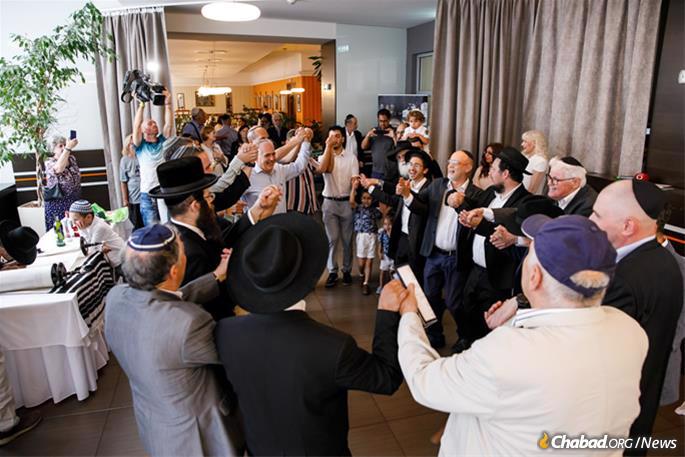 Celebrating inside the hotel venue, where a ceremony finalizing the letters in the Torah scroll was held.