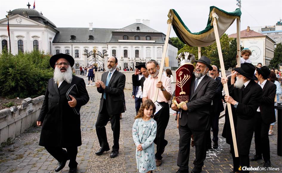 The first new Torah scroll to have been written in Slovakia since the Jewish community was decimated by the Nazis during the Holocaust is greeted by a celebratory procession through the capital city of Bratislava and past the Presidential Palace to a new Chabad center established in 2017.
