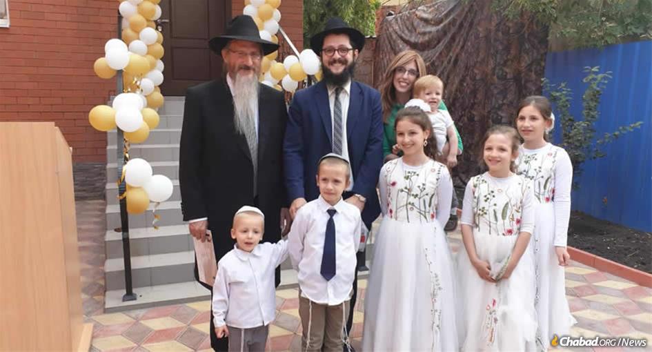 Chief Rabbi of Russia Berel Lazar, left, with Rabbi Yisroel and Deborah Melamed, and their children, in front of the new mikvah in Astrakhan, Russia.