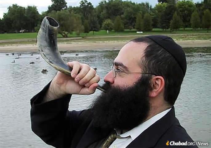 Rabbi Yossi Serebryanski, co-director of Chabad of South Denver, Colo., blows shofar in Washington Park there. It&#39;s a trend that has Jews of all ages, but particularly younger ones less drawn to synagogues than previous generations, coming out in full force for the High Holiday mitzvah. (File photo. Not taken on Rosh Hashanah).