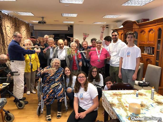 Members of Romania's CTeen chapter visit the elderly.
