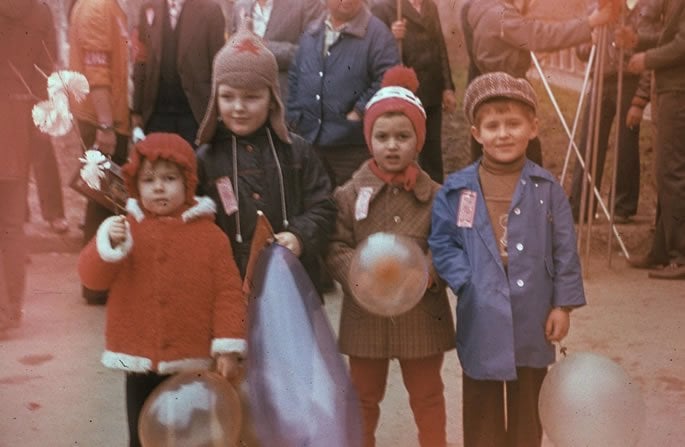 Typical picture of Soviet children at one of the Soviet parades. I am the second from the right, in a brown coat. Large military parades in Red Square, attended by top leaders of the Kremlin, especially the Politburo, became an enduring symbol of the Cold War period.