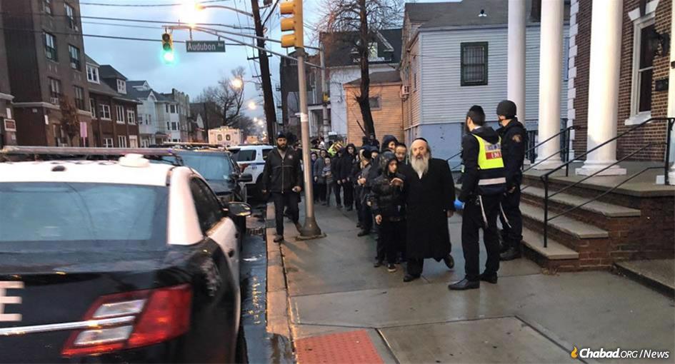 Students are evacuated from a yeshivah in Jersey City, N.J., near the scene of a shooting that left six dead. (Photo: @hasidic_1/Twitter)